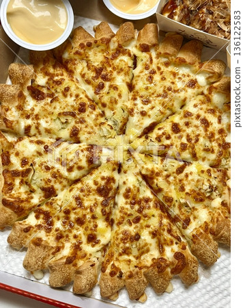 A delicious pizza with a golden crust, melted cheese, and savory toppings. Perfect for food-related designs, menus, or Italian-themed projects, capturing the essence of a classic comfort dish. 136122583