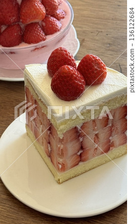A delectable slice of cake with rich layers of cream and frosting, topped with fresh fruit or sprinkles. Perfect for dessert photography, showcasing indulgence and sweetness in food-related projects. 136122684