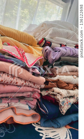 Clothes hanging neatly on hangers under the sun, gently swaying in the breeze—offering a perfect glimpse of fresh laundry days, clean fabric, and simple everyday beauty in every scene. 136122698