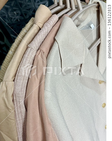 Clothes hanging neatly on hangers under the sun, gently swaying in the breeze—offering a perfect glimpse of fresh laundry days, clean fabric, and simple everyday beauty in every scene. 136122813