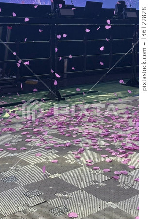 Colorful confetti falling through the air during a concert, creating a festive and energetic atmosphere with vibrant pieces scattering over the crowd and stage under bright lights Colorful confetti falling through the air during a concert, creating a festive and energetic atmosphere with vibrant pieces scattering over the crowd and stage under bright lights 136122828