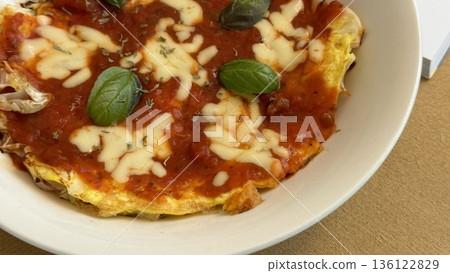 A delicious pizza with a golden crust, melted cheese, and savory toppings. Perfect for food-related designs, menus, or Italian-themed projects, capturing the essence of a classic comfort dish. 136122829