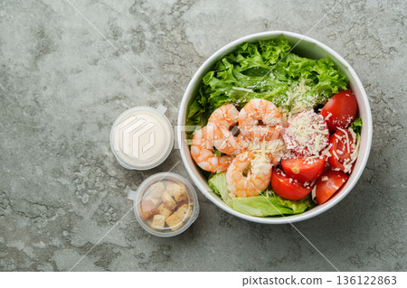 Fresh shrimp salad with lettuce and tomatoes served in a bowl with dressing and croutons Fresh shrimp salad with lettuce and tomatoes served in a bowl with dressing and croutons 136122863