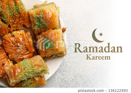 Sweets on a plate during Ramadan in a family gathering at home around evening time Sweets on a plate during Ramadan in a family gathering at home around evening time 136122893
