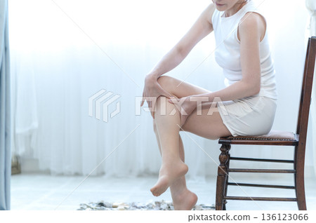 Woman doing leg massage 136123066