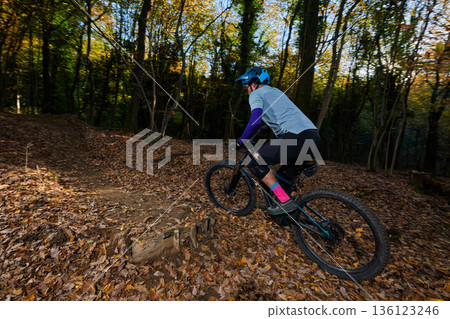 Autumn Forest Mountain Bike Rider Navigates Leaf-Covered Trail With Energy and Focus Autumn Forest Mountain Bike Rider Navigates Leaf-Covered Trail With Energy and Focus 136123246