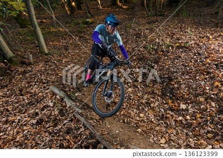 Autumn Mountain Biker Navigates Leaf-Litter Trail With Speed, Focus, and Adventure Autumn Mountain Biker Navigates Leaf-Litter Trail With Speed, Focus, and Adventure 136123399