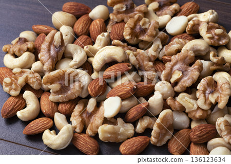 Mixed nuts in a wooden bowl Mixed nuts in a wooden bowl 136123634