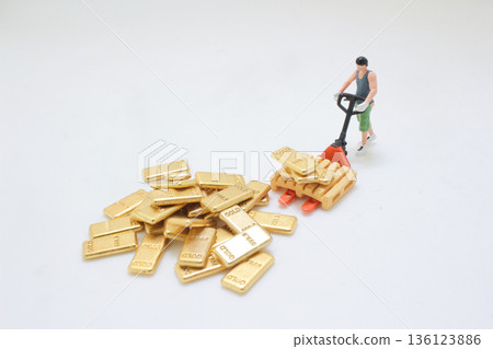 Miniature Workers Handling Stack Of Shiny Gold Ingots Miniature Workers Handling Stack Of Shiny Gold Ingots 136123886