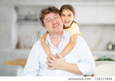 Father and little daughter posing in domestic interior 136123996