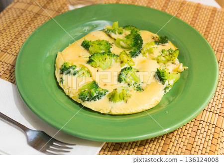wholesome breakfast. omelet with broccoli on green plate wholesome breakfast. omelet with broccoli on green plate 136124008
