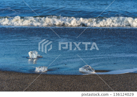 Jewelry ice washing up on Otsu Coast, Tokachi River Estuary, Hokkaido, Japan. 136124029