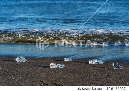 Jewelry ice washing up on Otsu Coast, Tokachi River Estuary, Hokkaido, Japan. Jewelry ice washing up on Otsu Coast, Tokachi River Estuary, Hokkaido, Japan. 136124032