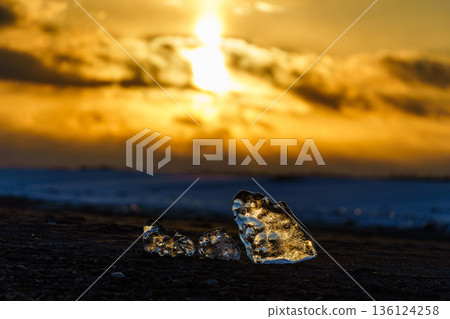 Jewelry ice illuminated by the setting sun. A fantastic seascape at Otsu Coast. Jewelry ice illuminated by the setting sun. A fantastic seascape at Otsu Coast. 136124258