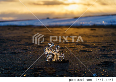 Jewelry ice illuminated by the setting sun. A fantastic seascape at Otsu Coast. Jewelry ice illuminated by the setting sun. A fantastic seascape at Otsu Coast. 136124261