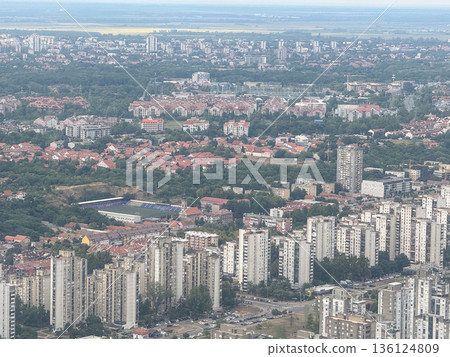 Aerial view of Belgrade residential districts and urban skyline from airplane. City density, housing development, and metropolitan expansion through infrastructure, population, and planning Aerial view of Belgrade residential districts and urban skyline from airplane. City density, housing development, and metropolitan expansion through infrastructure, population, and planning 136124809