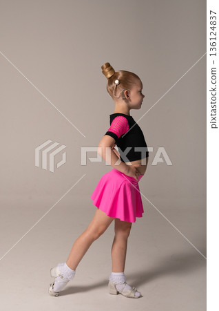 Portrait of child with cochlear implant during dance practice in studio. Hearing loss treatment, auditory rehabilitation, assistive medical device, emotional adaptation, and inclusive healthcare Portrait of child with cochlear implant during dance practice in studio. Hearing loss treatment, auditory rehabilitation, assistive medical device, emotional adaptation, and inclusive healthcare 136124837