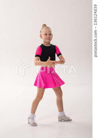 Young dancer with cochlear implant performing expressive sport dance movement. Hearing loss rehabilitation, auditory therapy, assistive technology, physical coordination, and confidence growth 136124839