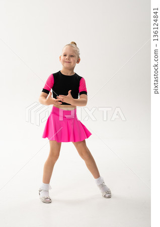 Young dancer with cochlear implant performing expressive sport dance movement. Hearing loss rehabilitation, auditory therapy, assistive technology, physical coordination, and confidence growth 136124841