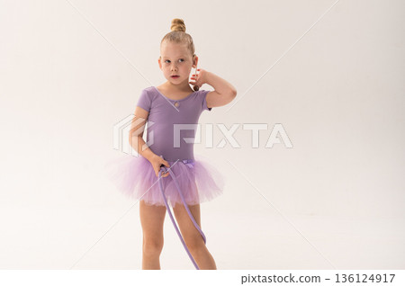 Portrait of young gymnast child with cochlear implant in studio. Hearing loss treatment, cochlear implant rehabilitation, inclusive childhood sport, confidence building, and social integration Portrait of young gymnast child with cochlear implant in studio. Hearing loss treatment, cochlear implant rehabilitation, inclusive childhood sport, confidence building, and social integration 136124917