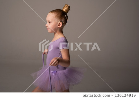 Portrait of young gymnast child with cochlear implant in studio. Hearing loss treatment, cochlear implant rehabilitation, inclusive childhood sport, confidence building, and social integration Portrait of young gymnast child with cochlear implant in studio. Hearing loss treatment, cochlear implant rehabilitation, inclusive childhood sport, confidence building, and social integration 136124919