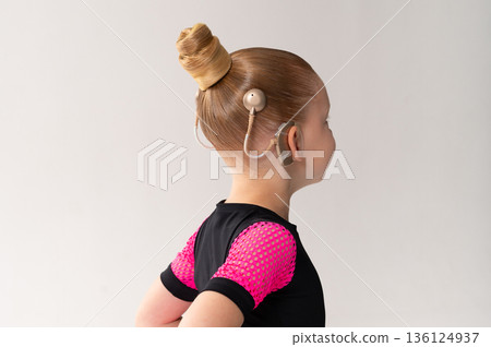 Child head with cochlear implant hearing aid 136124937