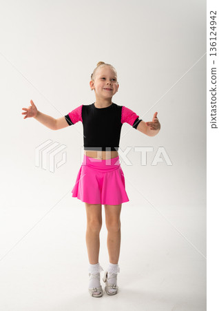Young dancer with cochlear implant performing expressive sport dance movement. Hearing loss rehabilitation, auditory therapy, assistive technology, physical coordination, and confidence growth 136124942