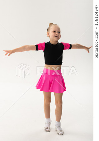 Portrait of child with cochlear implant during dance practice in studio. Hearing loss treatment, auditory rehabilitation, assistive medical device, emotional adaptation, and inclusive healthcare 136124947