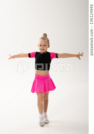 Young dancer with cochlear implant performing expressive sport dance movement. Hearing loss rehabilitation, auditory therapy, assistive technology, physical coordination, and confidence growth 136124948