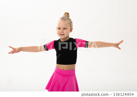 Young dancer with cochlear implant performing expressive sport dance movement. Hearing loss rehabilitation, auditory therapy, assistive technology, physical coordination, and confidence growth 136124954