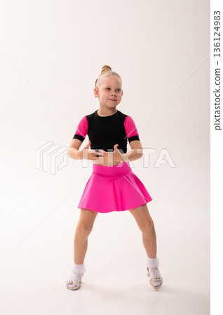 Portrait of child with cochlear implant during dance practice in studio. Hearing loss treatment, auditory rehabilitation, assistive medical device, emotional adaptation, and inclusive healthcare 136124983
