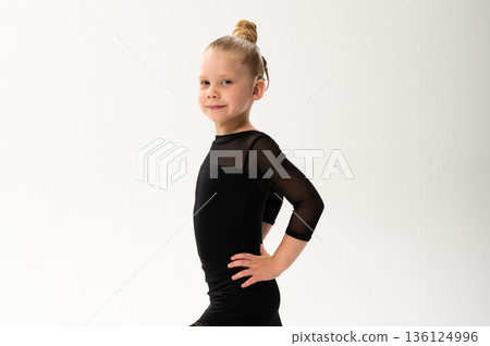 Portrait of child with cochlear implant during dance practice in studio. Hearing loss treatment, auditory rehabilitation, assistive medical device, emotional adaptation, and inclusive healthcare 136124996