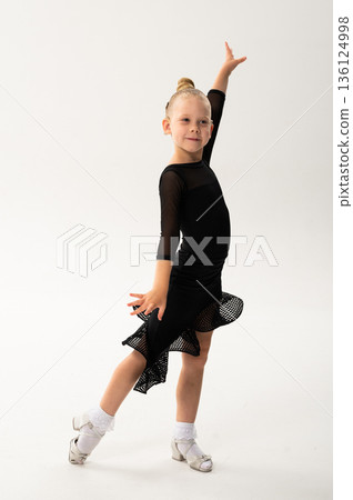Young dancer with cochlear implant performing expressive sport dance movement. Hearing loss rehabilitation, auditory therapy, assistive technology, physical coordination, and confidence growth 136124998