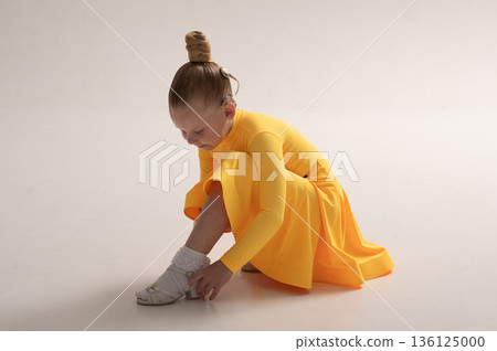 Young girl with cochlear implant in studio. Hearing impairment rehabilitation, auditory therapy, assistive hearing technology, inclusive childhood development, and confidence building 136125000
