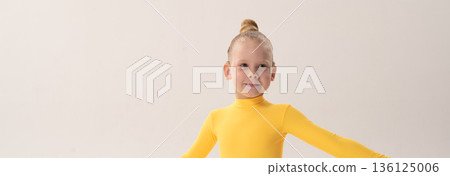 Banner child with cochlear implant during sport dance practice in studio. Copy space. Hearing loss treatment, auditory rehabilitation, assistive technology, body coordination, and inclusive physical 136125006