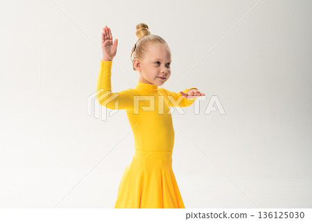 Child with cochlear implant practicing sport dance choreography in studio. Hearing impairment treatment, auditory therapy, rehabilitation process, assistive hearing technology, and inclusive physical 136125030