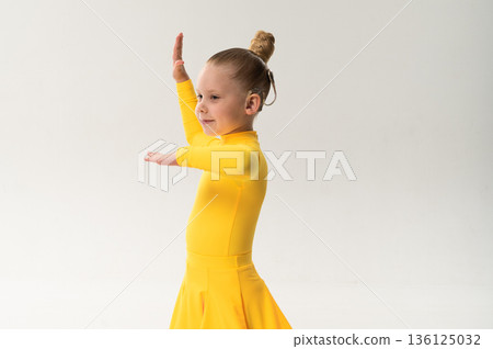 Side view of child with cochlear implant during sport dance practice in studio. Copy space. Hearing loss treatment, auditory rehabilitation, assistive technology, body coordination, and inclusive 136125032