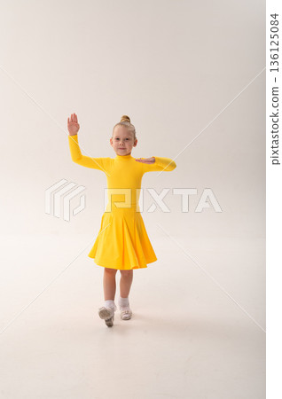 Young dancer with cochlear implant performing expressive movement in studio. Hearing loss rehabilitation, auditory training, assistive medical technology, inclusive sport dance, and physical Young dancer with cochlear implant performing expressive movement in studio. Hearing loss rehabilitation, auditory training, assistive medical technology, inclusive sport dance, and physical 136125084