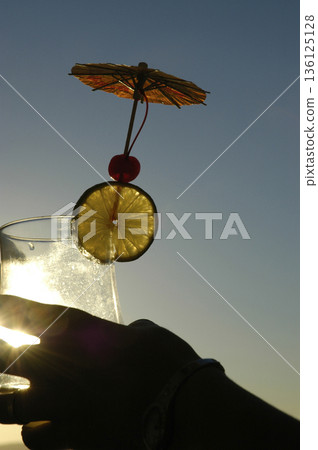 cocktail glass with ornaments photographed against the light 136125128