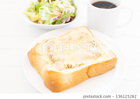A delicious breakfast of thick-cut tuna and cheese toast, vegetable salad, and coffee 136125262