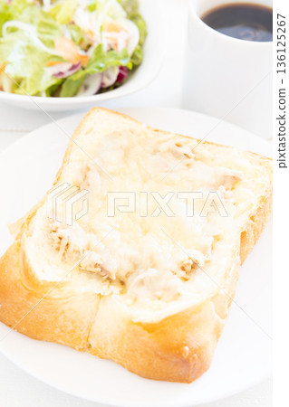 A delicious breakfast of thick-cut tuna and cheese toast, vegetable salad, and coffee 136125267