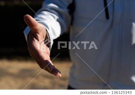 Stock photo of a man asking for a handshake 136125343