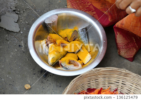 Preparing spicy and hot fish curry in mud kitchen stove in village outside home, Kumrokhali, West Bengal, India Preparing spicy and hot fish curry in mud kitchen stove in village outside home, Kumrokhali, West Bengal, India 136125479