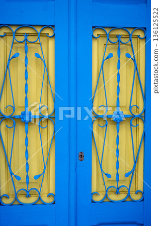 blue and yellow wooden door 136125522