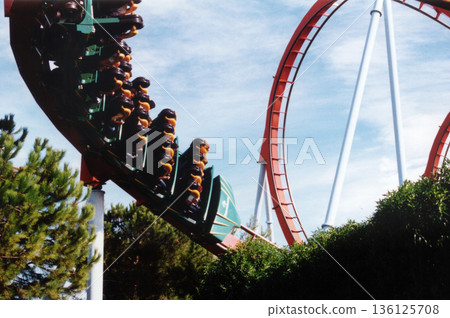 images of the roller coaster in a large amusement park 136125708