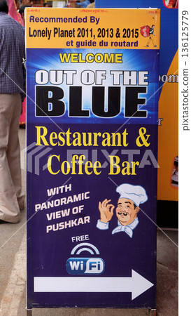 The advertising stand board for show advertising information about the restaurant in Pushkar, Rajasthan, India 136125779