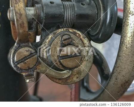 set of screws, rollers and other mechanisms that are part of an old sewing machine set of screws, rollers and other mechanisms that are part of an old sewing machine 136126009