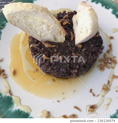 plate of black pudding cake with honey and mustard sauce decorated with bread toasts plate of black pudding cake with honey and mustard sauce decorated with bread toasts 136126074