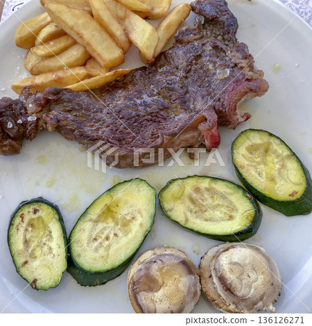 entrecote cooked to the point with potatoes and grilled zucchini entrecote cooked to the point with potatoes and grilled zucchini 136126271