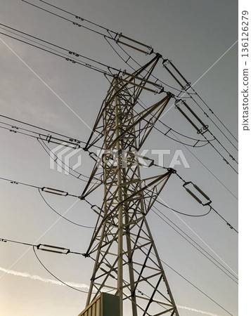 high voltage electrical tower with blue sky background high voltage electrical tower with blue sky background 136126279
